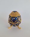 This elegant Limoges egg features a stunning blue design with sparkling Swarovski crystals, making it a perfect addition to any collection or a luxurious gift for special occasions.